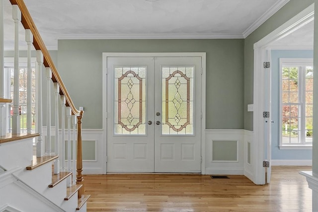 foyer entrance with a healthy amount of sunlight, french doors, and stairs