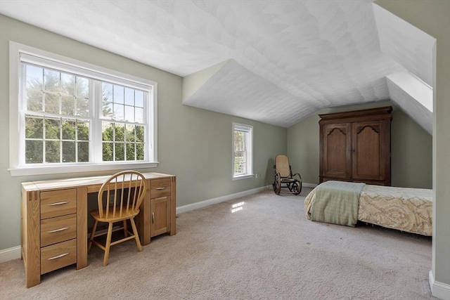 bedroom with baseboards, light colored carpet, and lofted ceiling