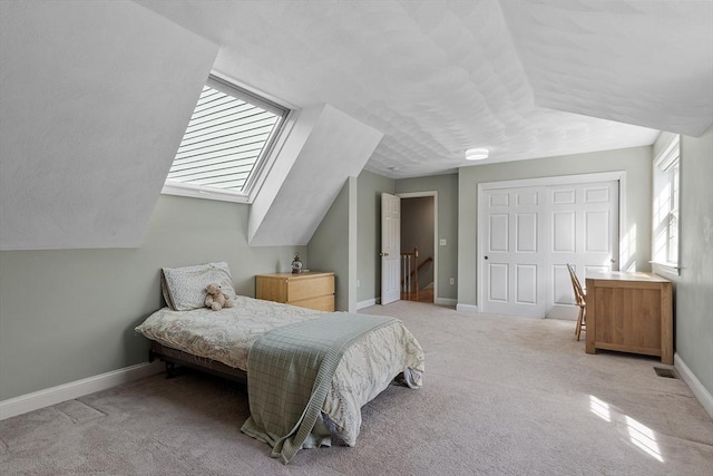 carpeted bedroom featuring baseboards, visible vents, and a closet