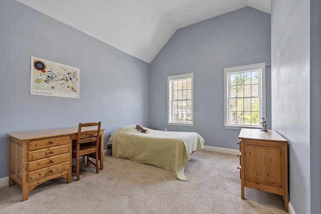 bedroom featuring baseboards, light carpet, and lofted ceiling