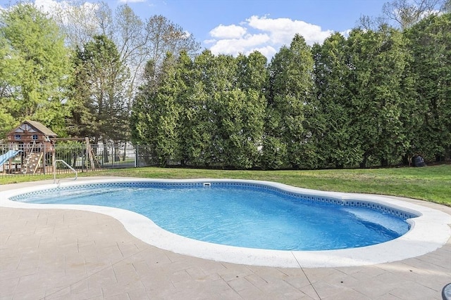 pool featuring fence, a playground, a patio, and a lawn