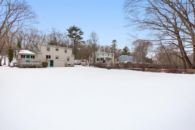 yard layered in snow featuring a wooden deck