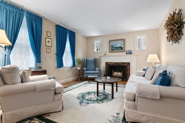 living room with hardwood / wood-style flooring and a brick fireplace