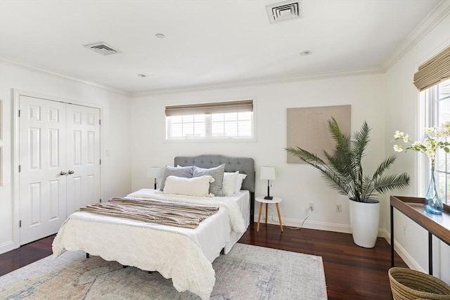 bedroom with ornamental molding, visible vents, and wood finished floors