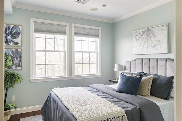 bedroom with baseboards, ornamental molding, visible vents, and dark wood-style floors