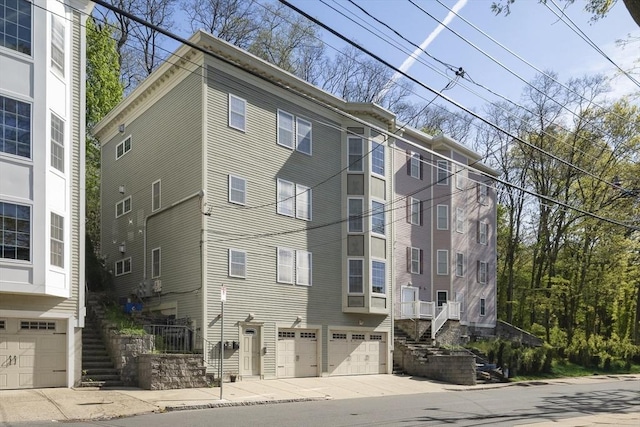 view of property with stairway and a garage