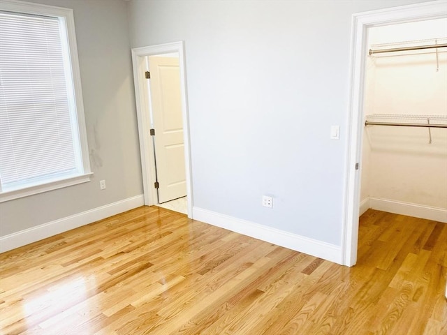 unfurnished bedroom with a closet and light hardwood / wood-style flooring