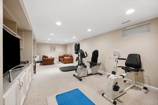 exercise area with recessed lighting, light colored carpet, and baseboards