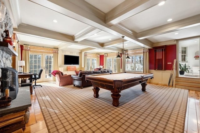 game room with beamed ceiling, french doors, light wood-style floors, and a wealth of natural light