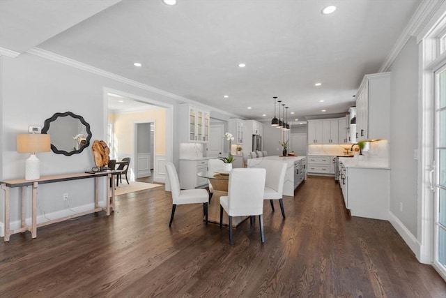 dining area with dark hardwood / wood-style flooring and ornamental molding