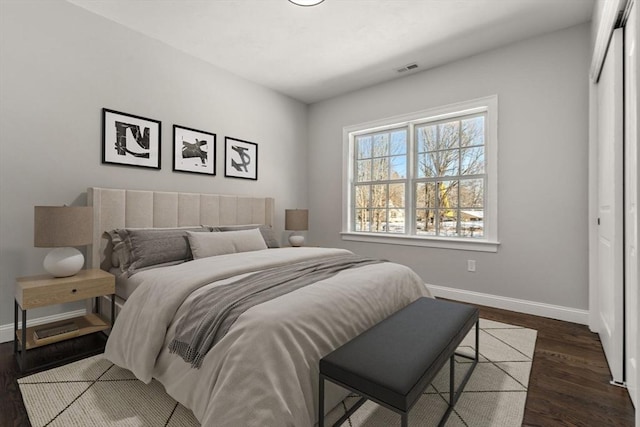 bedroom featuring dark hardwood / wood-style flooring and a closet