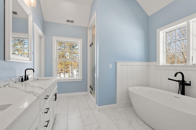 bathroom featuring lofted ceiling, vanity, and shower with separate bathtub