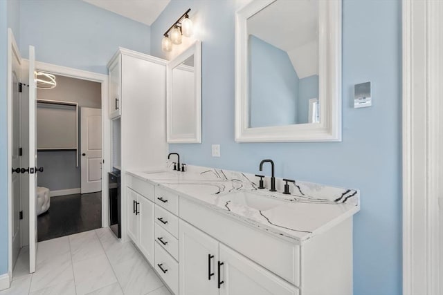 bathroom with vanity and vaulted ceiling