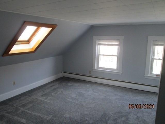 16 Chestnut, Wakefield, MA 01880 - additional living space with baseboard heating, carpet flooring, vaulted ceiling, baseboards, and a skylight