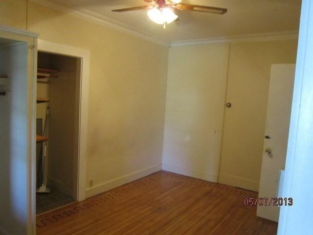 16 Chestnut, Wakefield, MA 01880 - unfurnished bedroom featuring ornamental molding, wood finished floors, baseboards, ceiling fan, and a closet