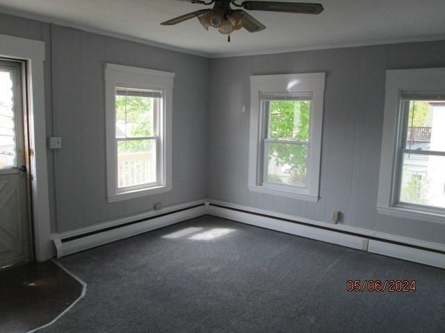 16 Chestnut, Wakefield, MA 01880 - carpeted empty room with healthy amount of natural light, a ceiling fan, a baseboard heating unit, and ornamental molding