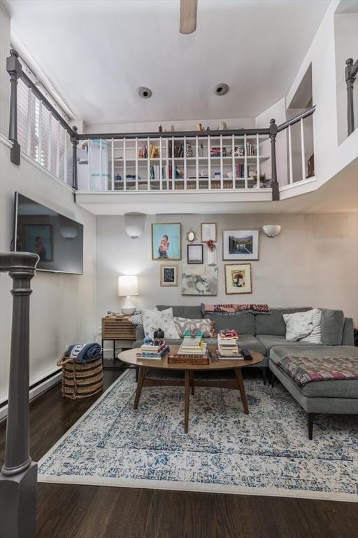 living area featuring wood finished floors and a high ceiling