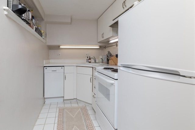 kitchen featuring open shelves, white appliances, a sink, light tile patterned floors, and light countertops