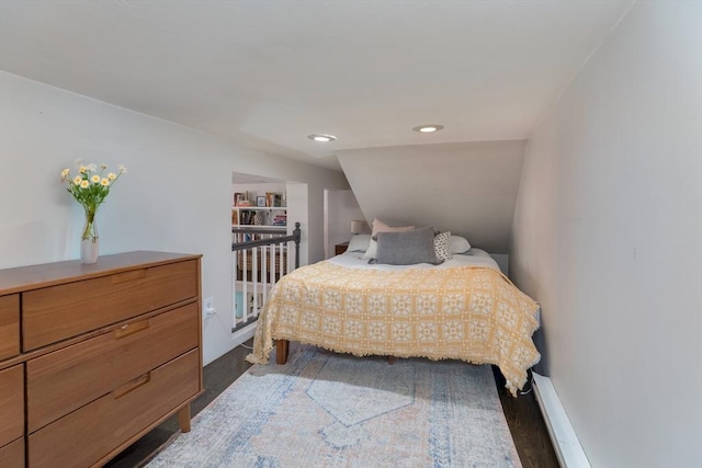 bedroom featuring dark wood-style floors, vaulted ceiling, and recessed lighting