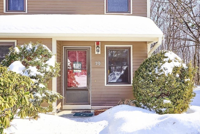 view of snow covered property entrance