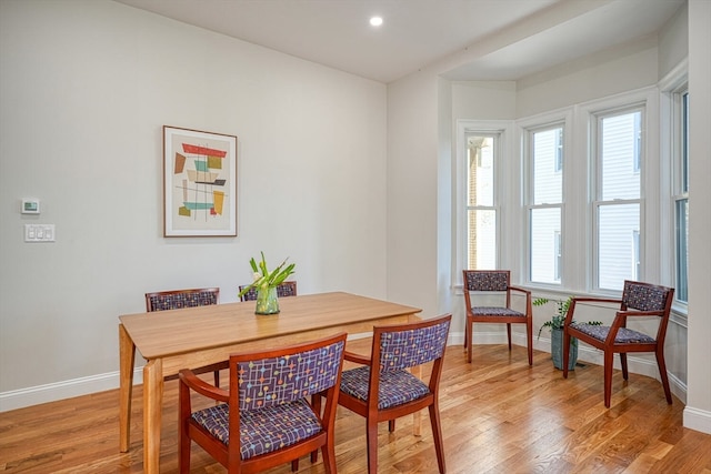 dining space featuring a wealth of natural light and light wood-type flooring