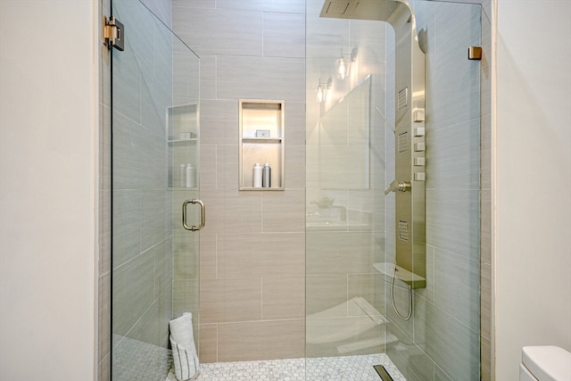 bathroom with toilet and an enclosed shower