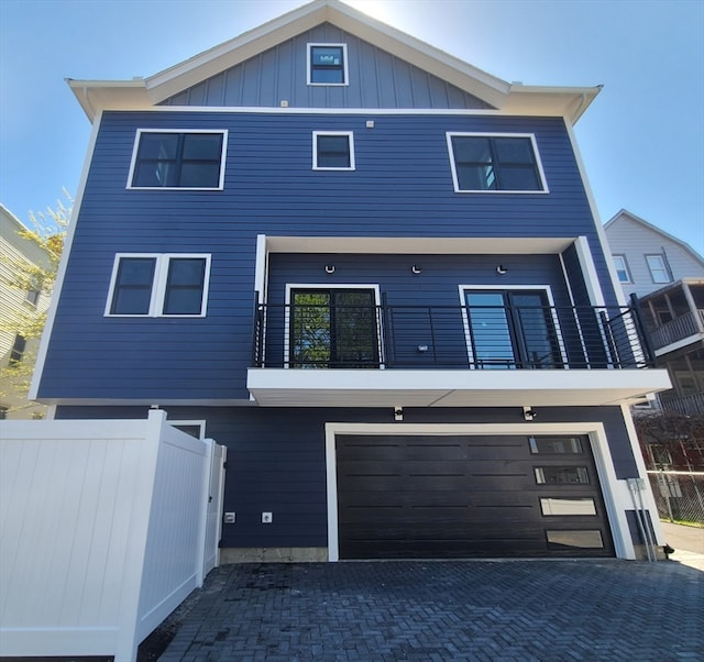 view of front of property featuring a garage and a balcony