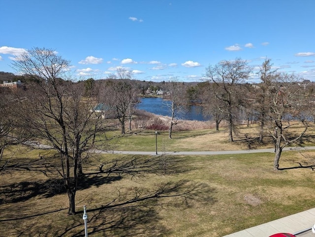 view of community featuring a yard and a water view