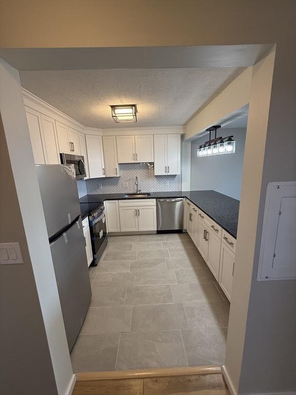 kitchen with sink, white cabinets, and stainless steel appliances