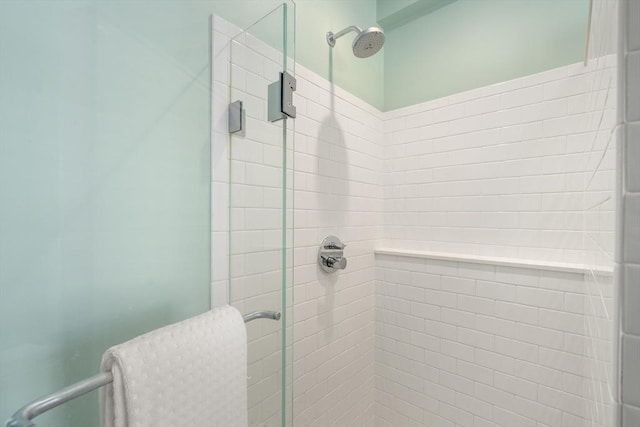 bathroom featuring a shower with door