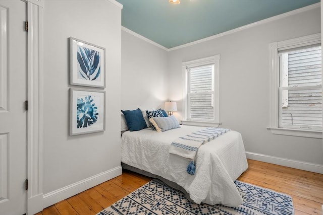 bedroom featuring ornamental molding and hardwood / wood-style floors