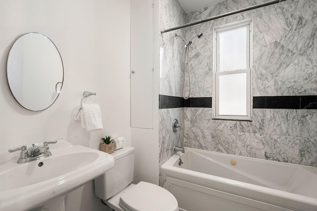 full bathroom featuring tiled shower / bath, sink, and toilet