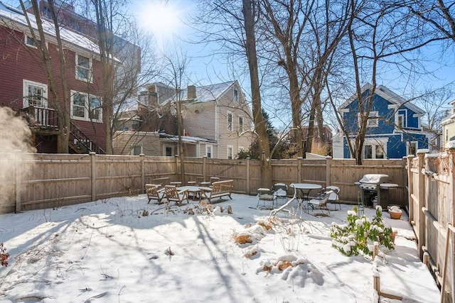 yard covered in snow with a fire pit