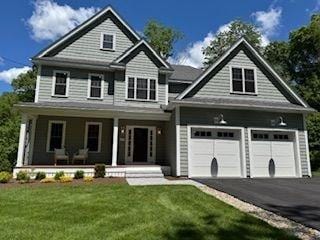 220 Mill St, Burlington, MA 01803 - view of front of property featuring a porch, asphalt driveway, and a front lawn
