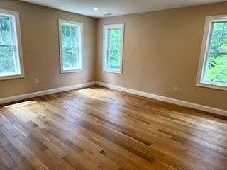 220 Mill St, Burlington, MA 01803 - unfurnished room featuring baseboards and dark wood-style floors