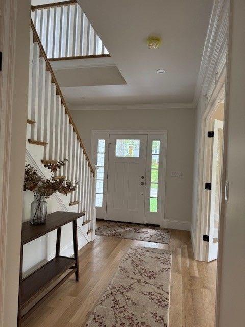 220 Mill St, Burlington, MA 01803 - foyer entrance featuring stairway, ornamental molding, wood finished floors, and baseboards