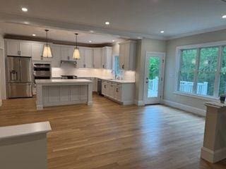 220 Mill St, Burlington, MA 01803 - kitchen featuring stainless steel fridge with ice dispenser, baseboards, wood finished floors, a kitchen island, and recessed lighting