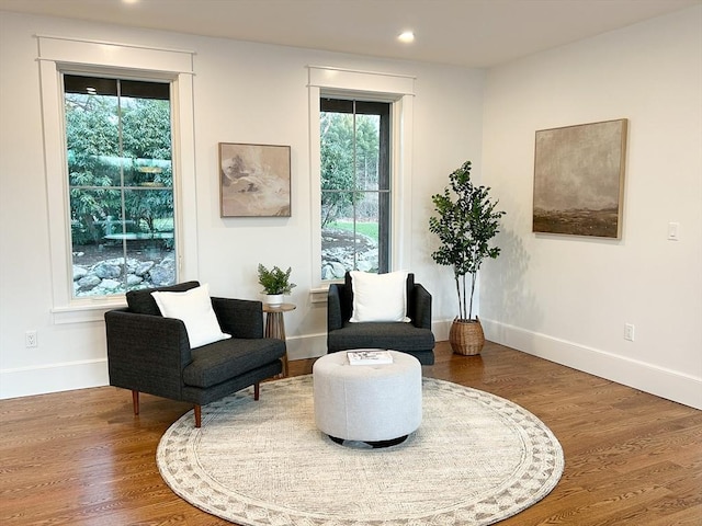 sitting room with hardwood / wood-style floors and plenty of natural light