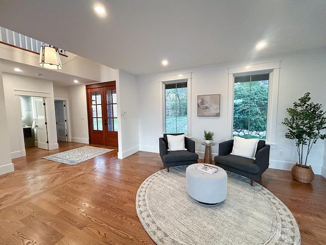 living area featuring french doors and hardwood / wood-style flooring