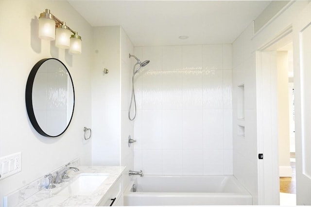 bathroom featuring vanity and tiled shower / bath combo