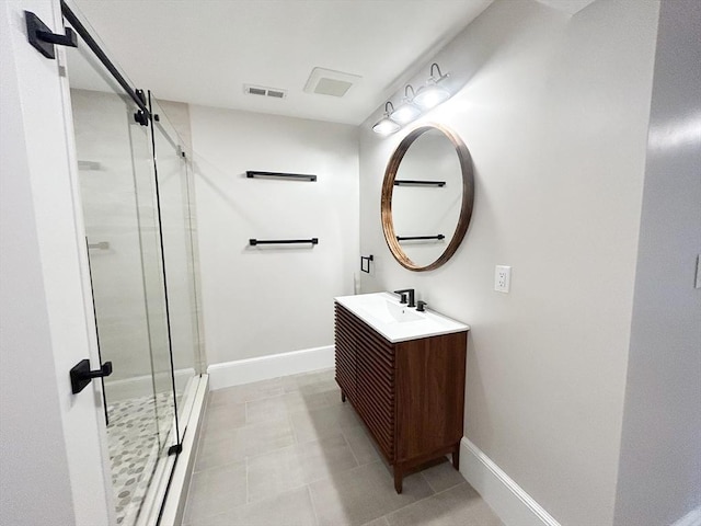 bathroom with vanity, tile patterned floors, and a shower with shower door