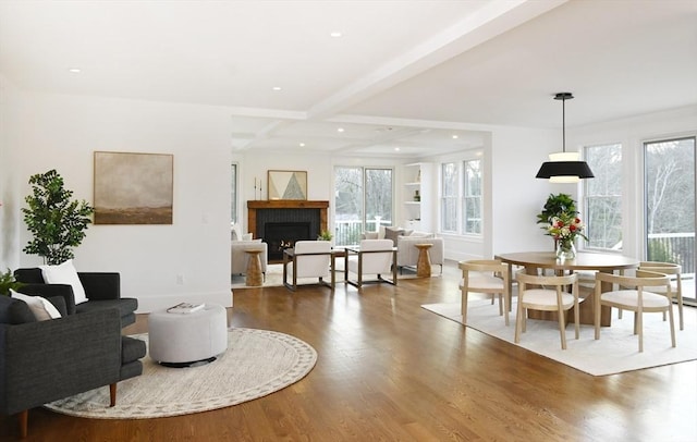 dining area with hardwood / wood-style floors and beamed ceiling