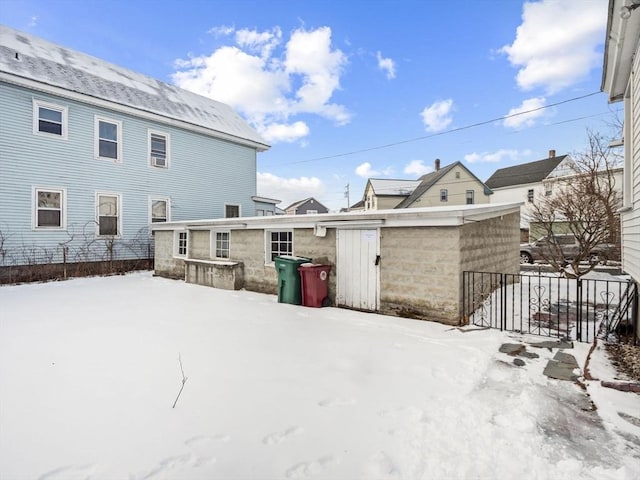 view of snow covered rear of property