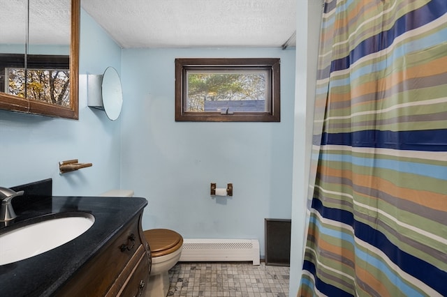 bathroom with vanity, toilet, a textured ceiling, and a baseboard heating unit