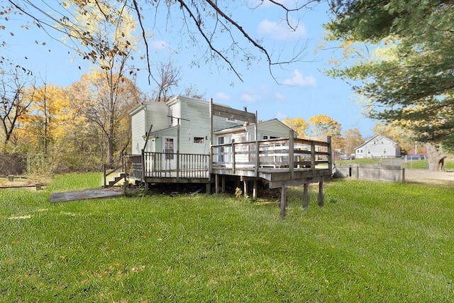 back of property with a deck and a lawn