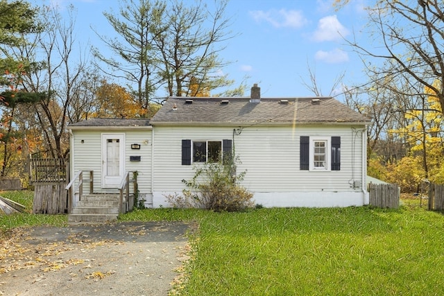 back of property featuring a yard