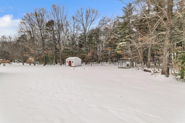 yard layered in snow with a storage unit