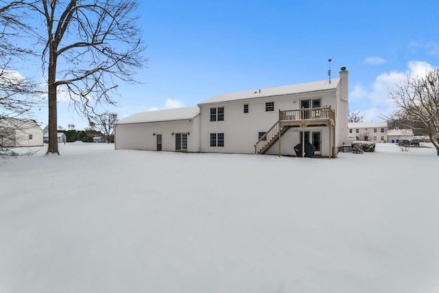 snow covered property featuring a wooden deck