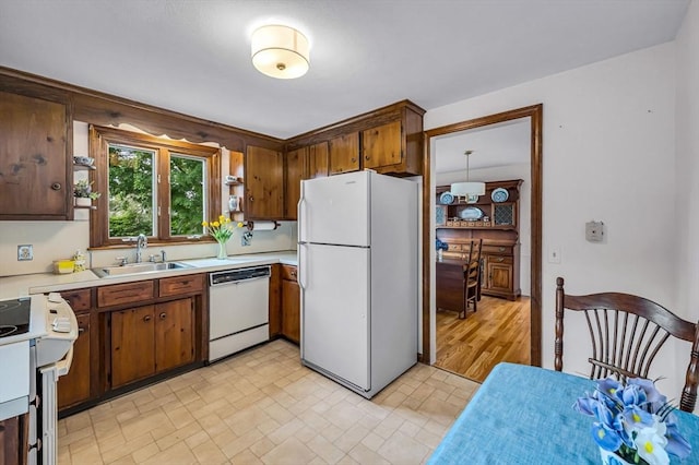 169 Mountainview Rd, East Longmeadow, MA 01028 - kitchen featuring white appliances, a sink, light countertops, and brown cabinets