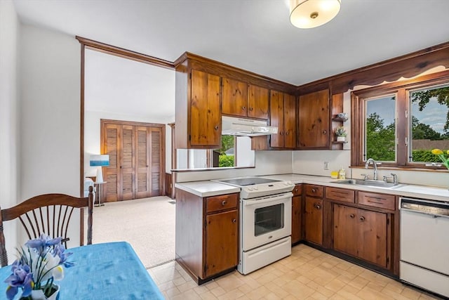 169 Mountainview Rd, East Longmeadow, MA 01028 - kitchen with white appliances, light countertops, a sink, under cabinet range hood, and brown cabinets